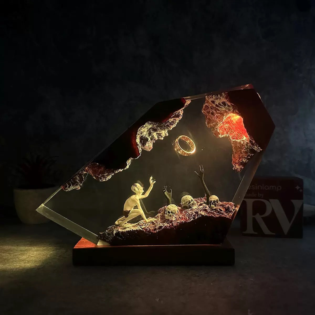 Dark fantasy resin lamp with glowing ring and skeletal scene